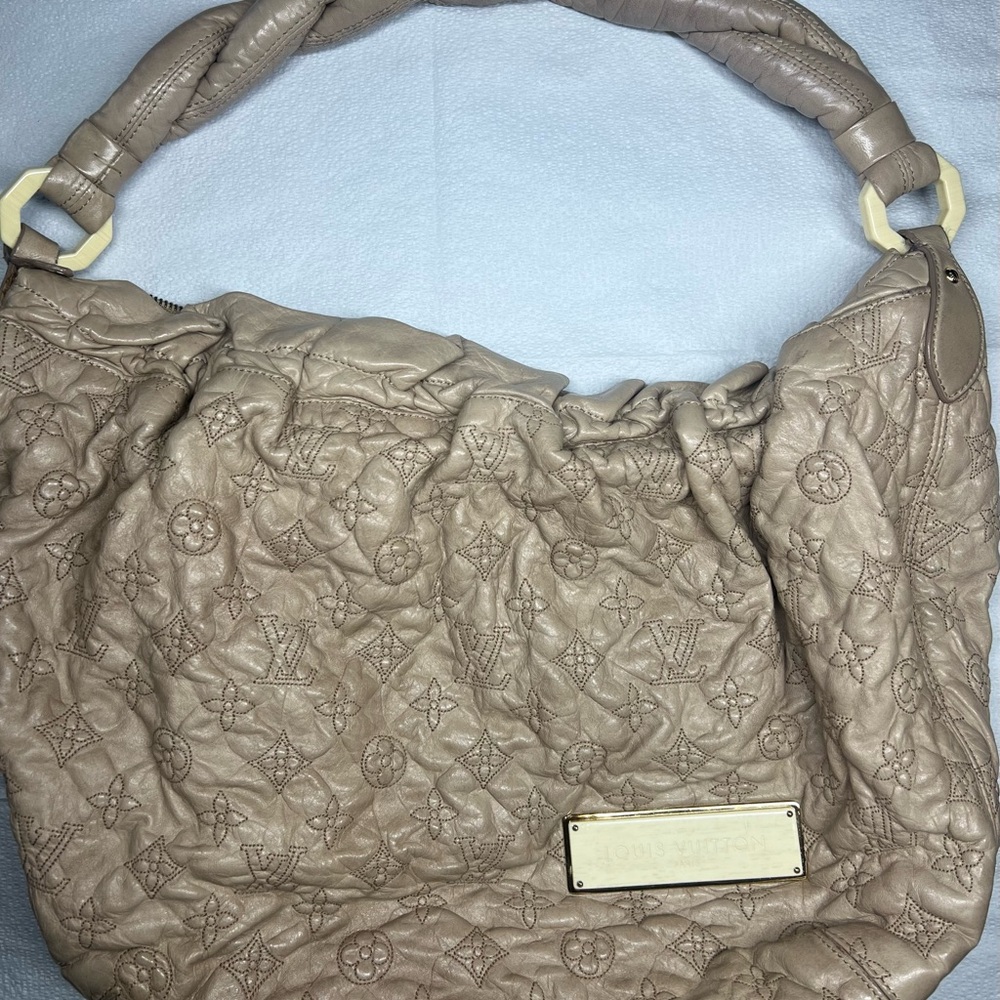 Louis Vuitton Beige Leather Monogram Olympe “Nimbus” Gm hobo Bag.
